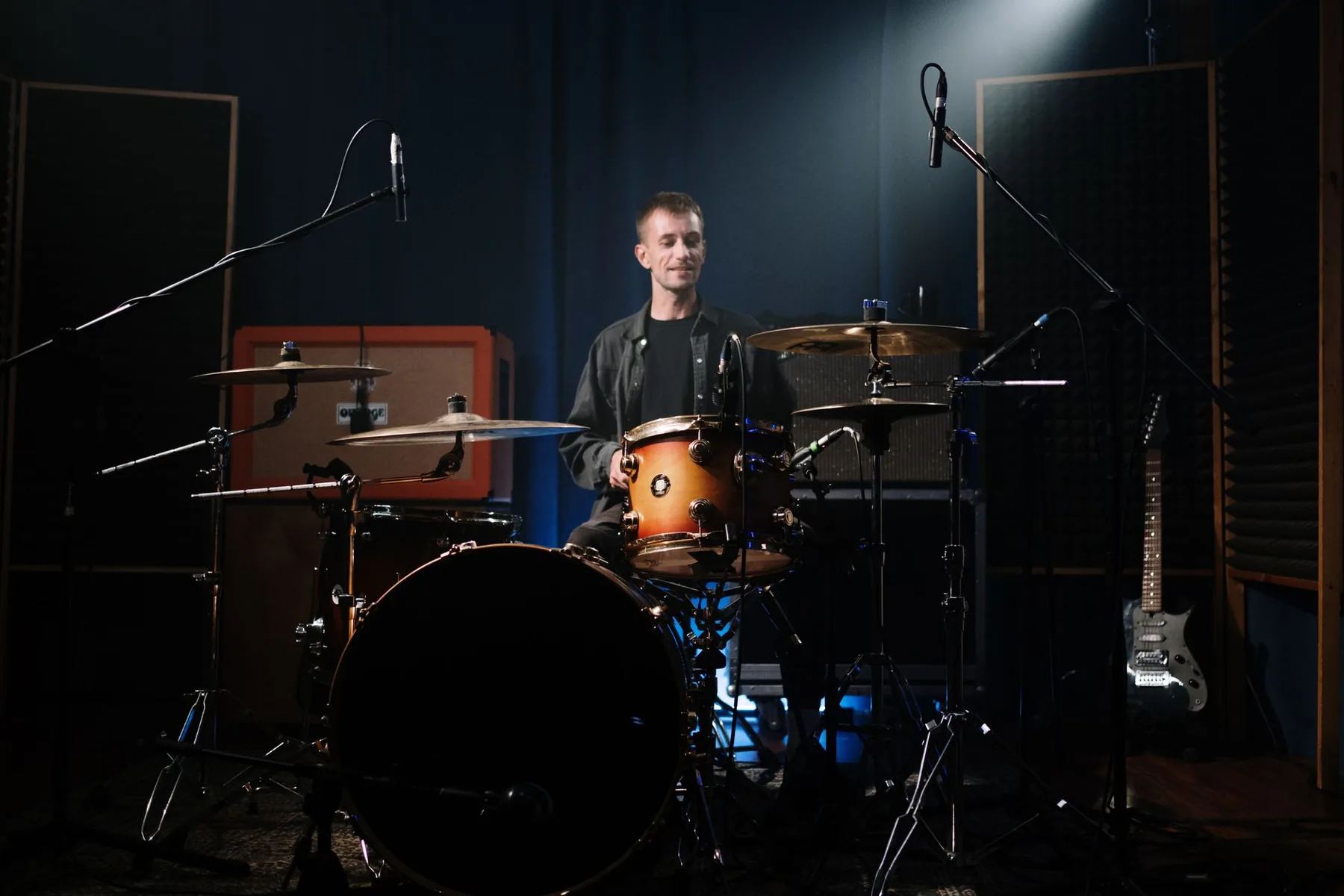 Drummer behind his drum kit in a studio Drummer behind his drum kit in a studio
