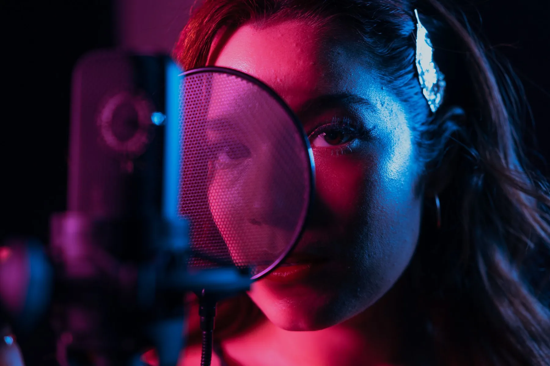 Singer at a microphone with a pop filter