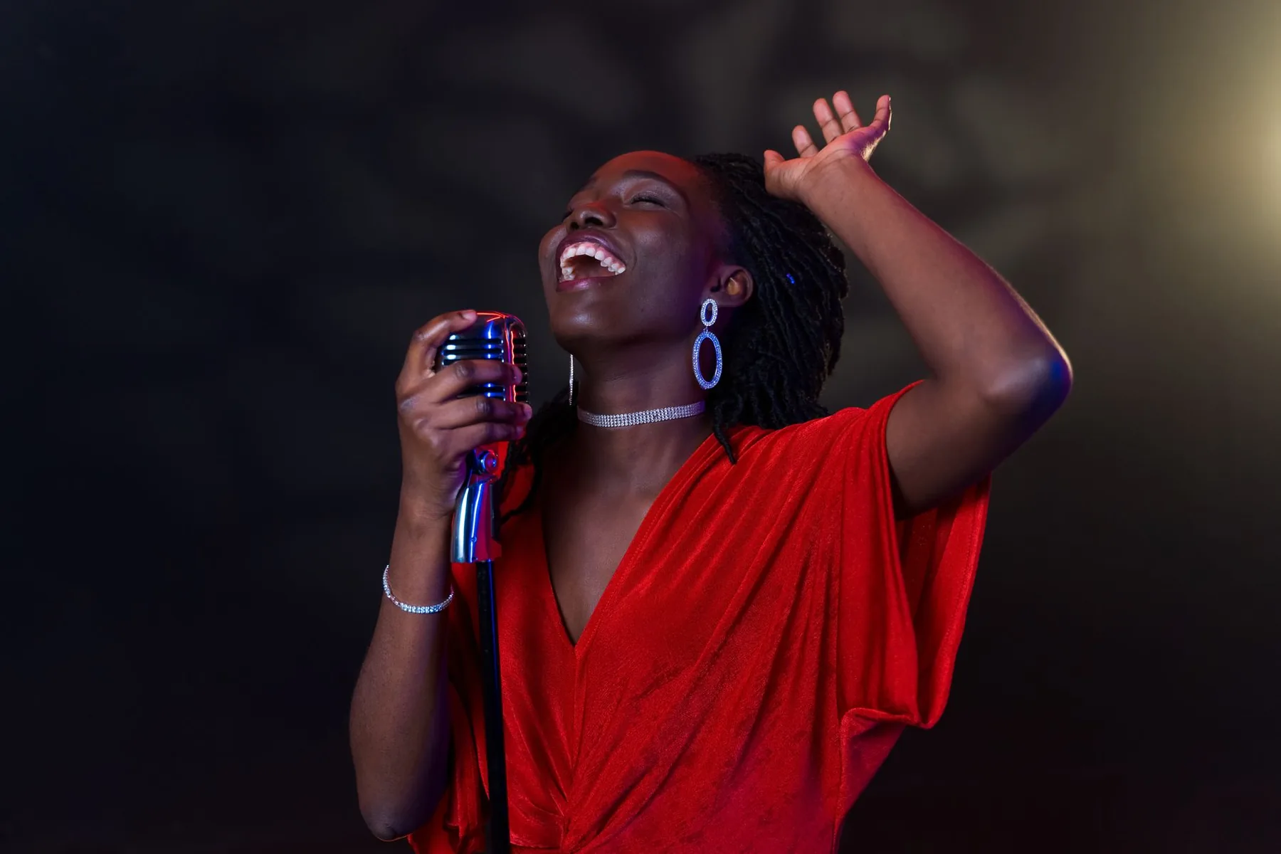 Singer in a red dress in front of a retro microphone Singer in a red dress in front of a retro microphone