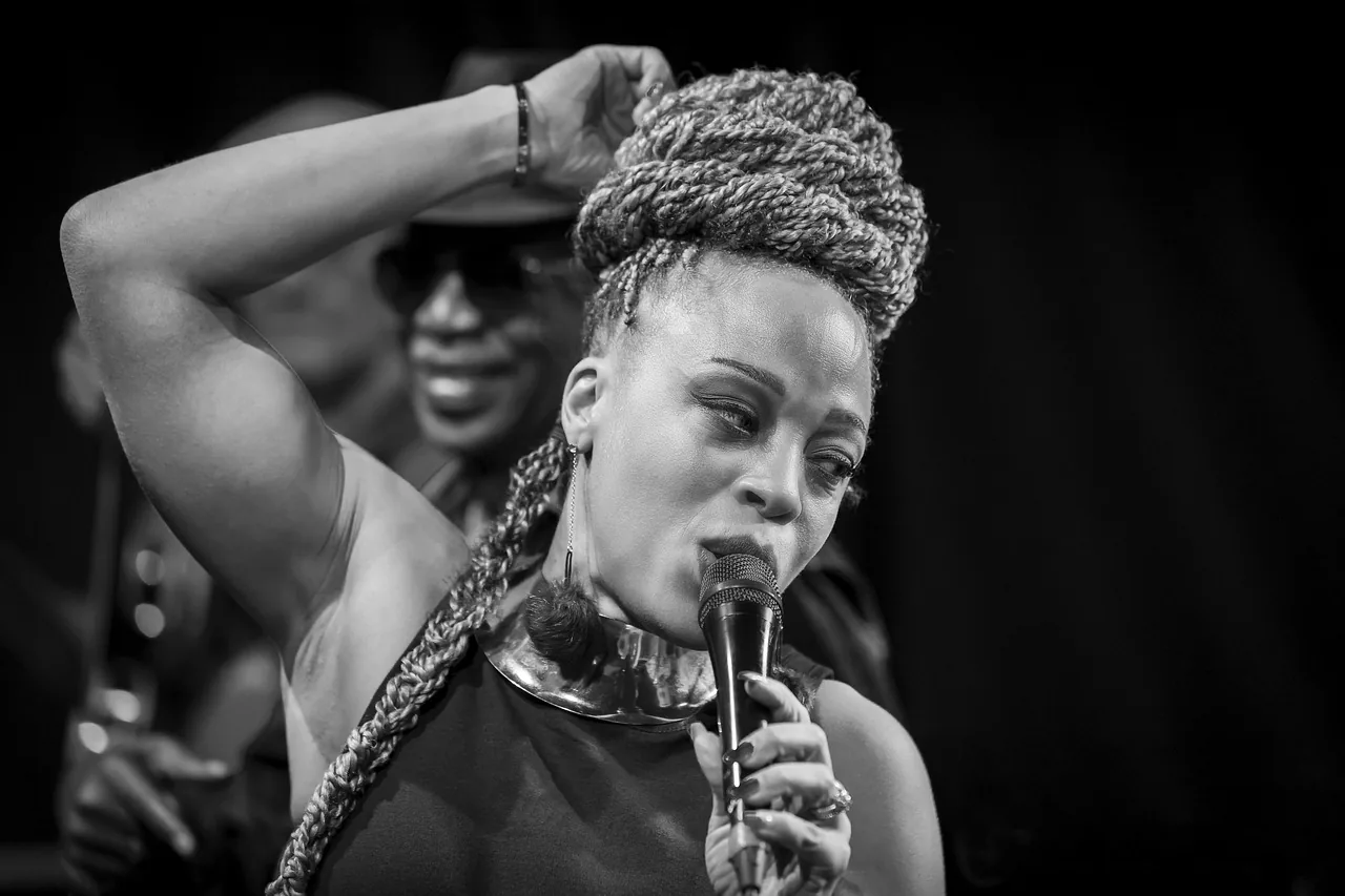 Singer onstage holding a microphone