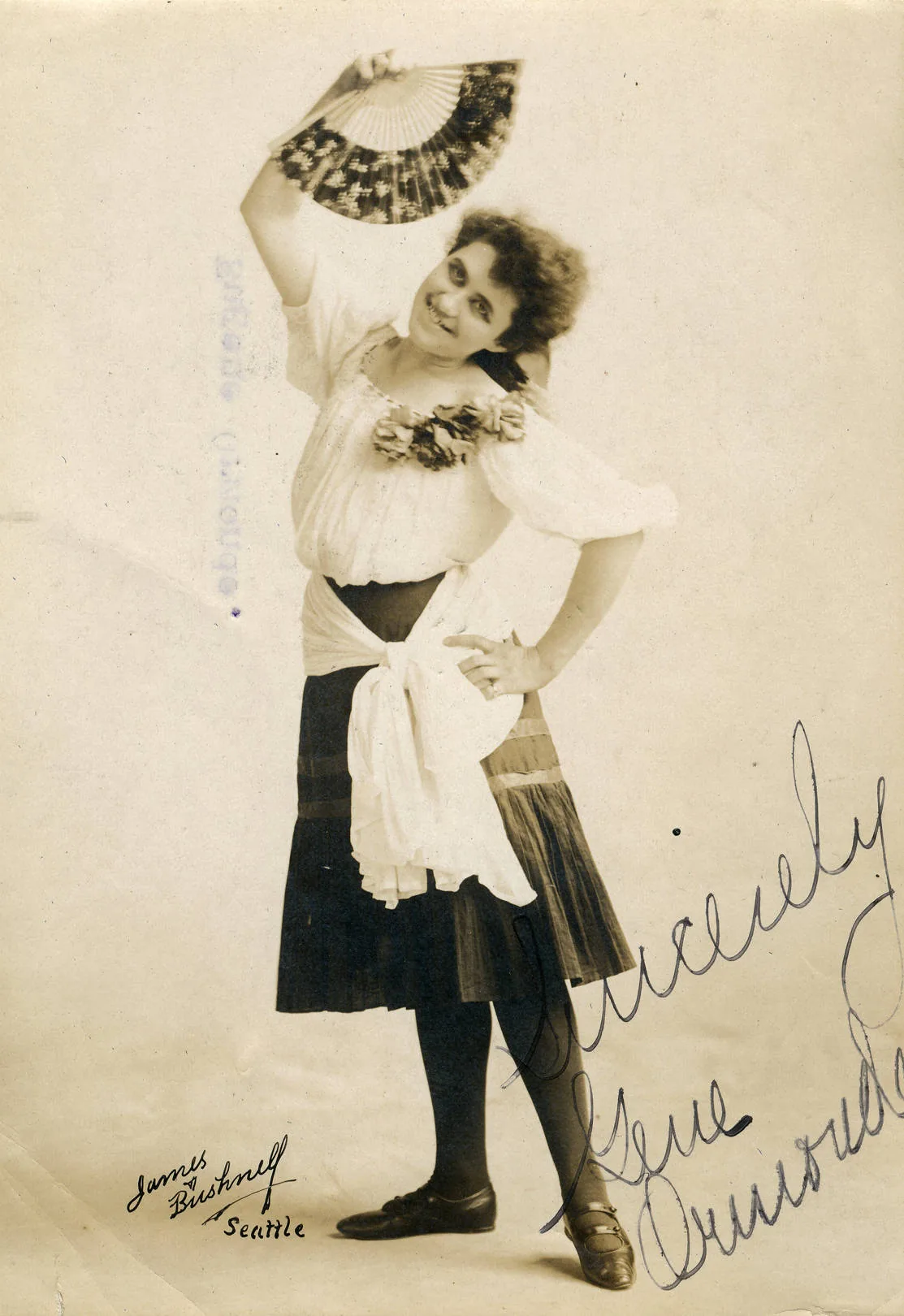 Vintage portrait of a woman in costume holding a fan