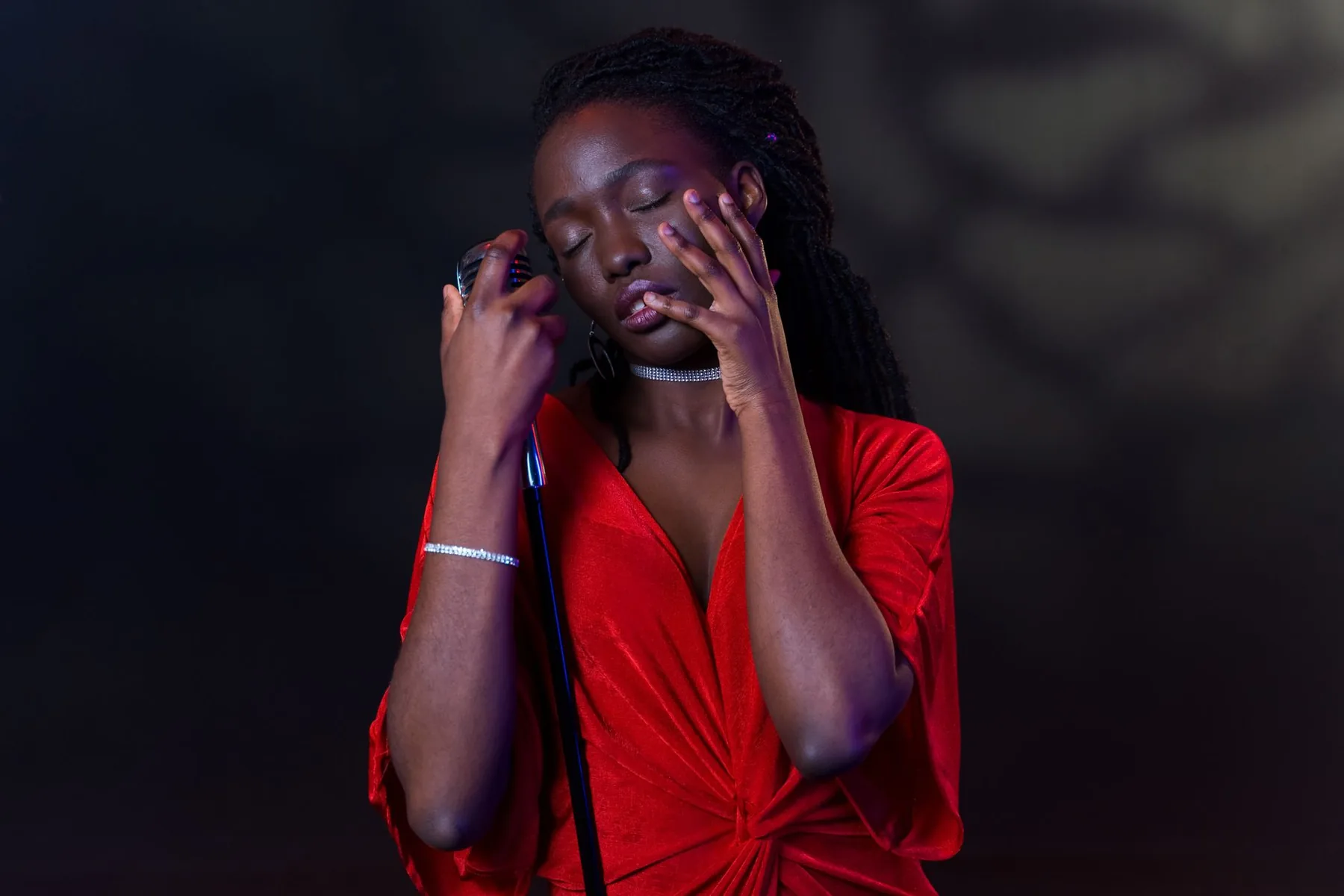 Singer in a red dress before a microphone