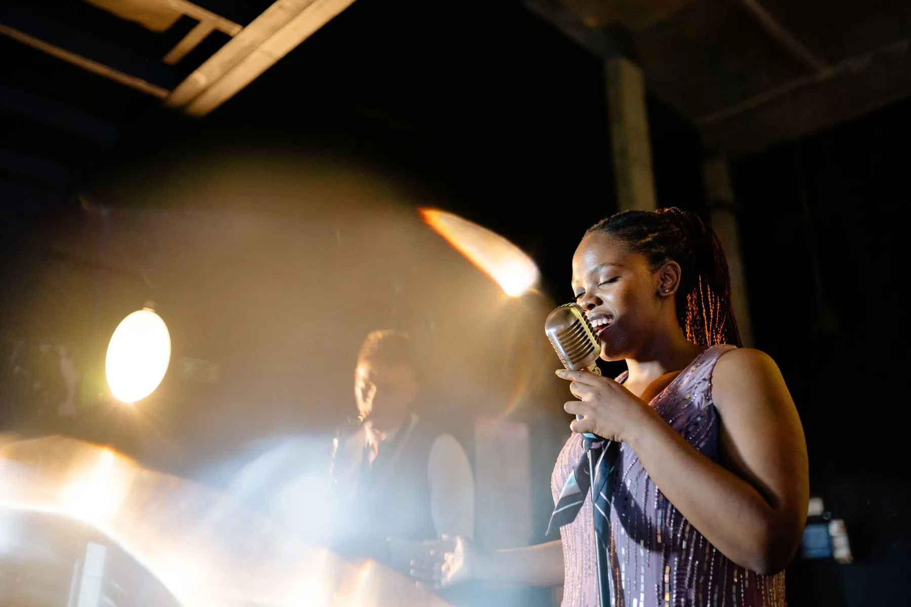 Black singer onstage under the spotlights Black singer onstage under the spotlights