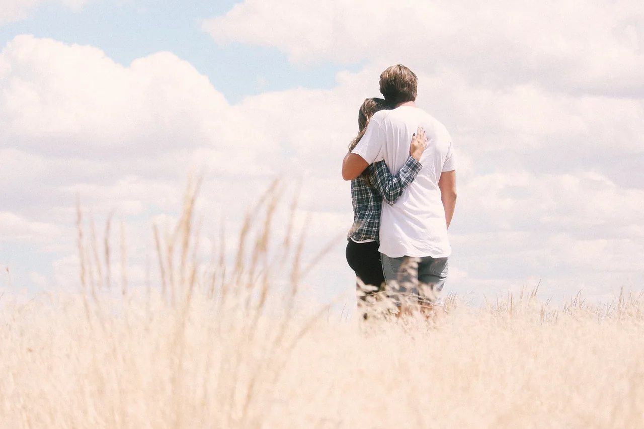 Couple embracing in a golden field Couple embracing in a golden field