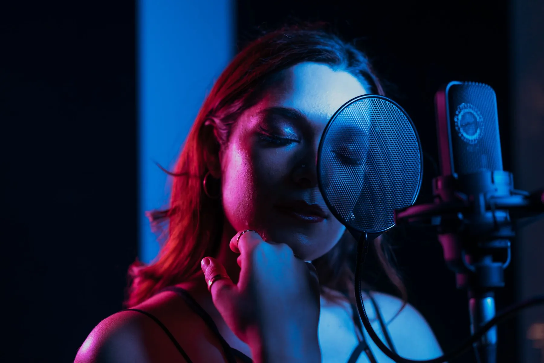 Singer in a studio under blue lighting