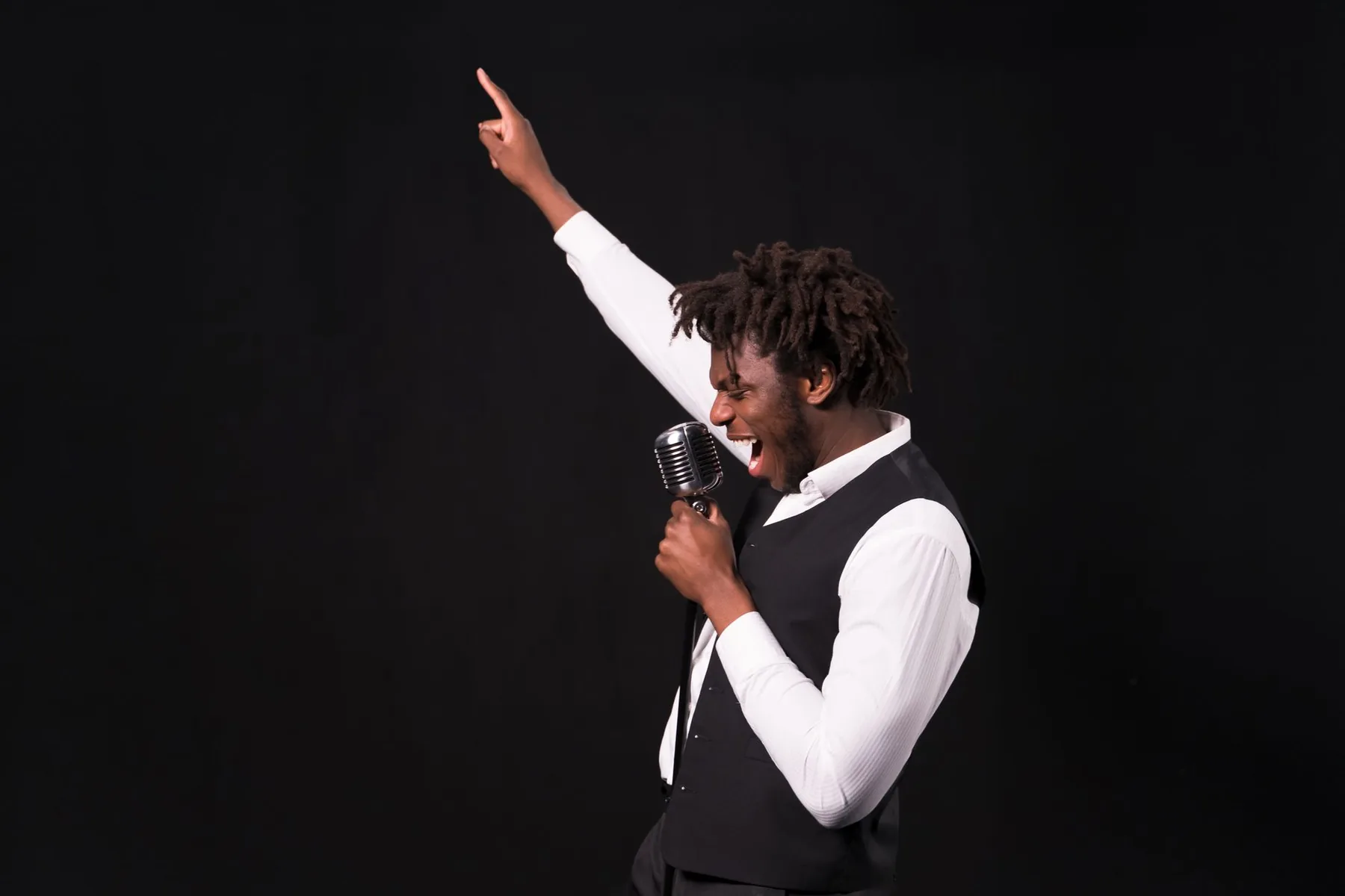 Singer raising his arm at a retro microphone Singer raising his arm at a retro microphone