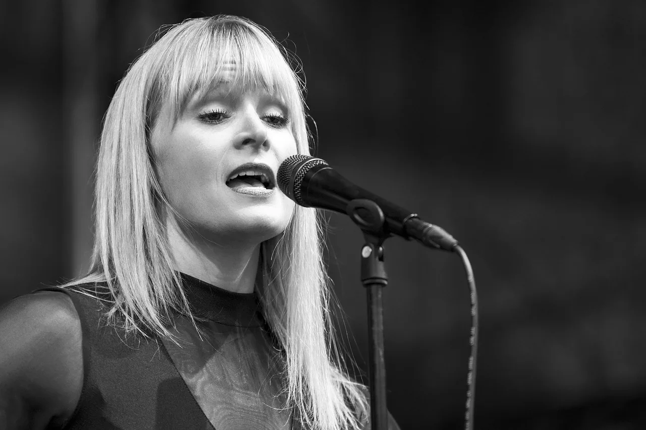 Female singer at a microphone in black and white Female singer at a microphone in black and white