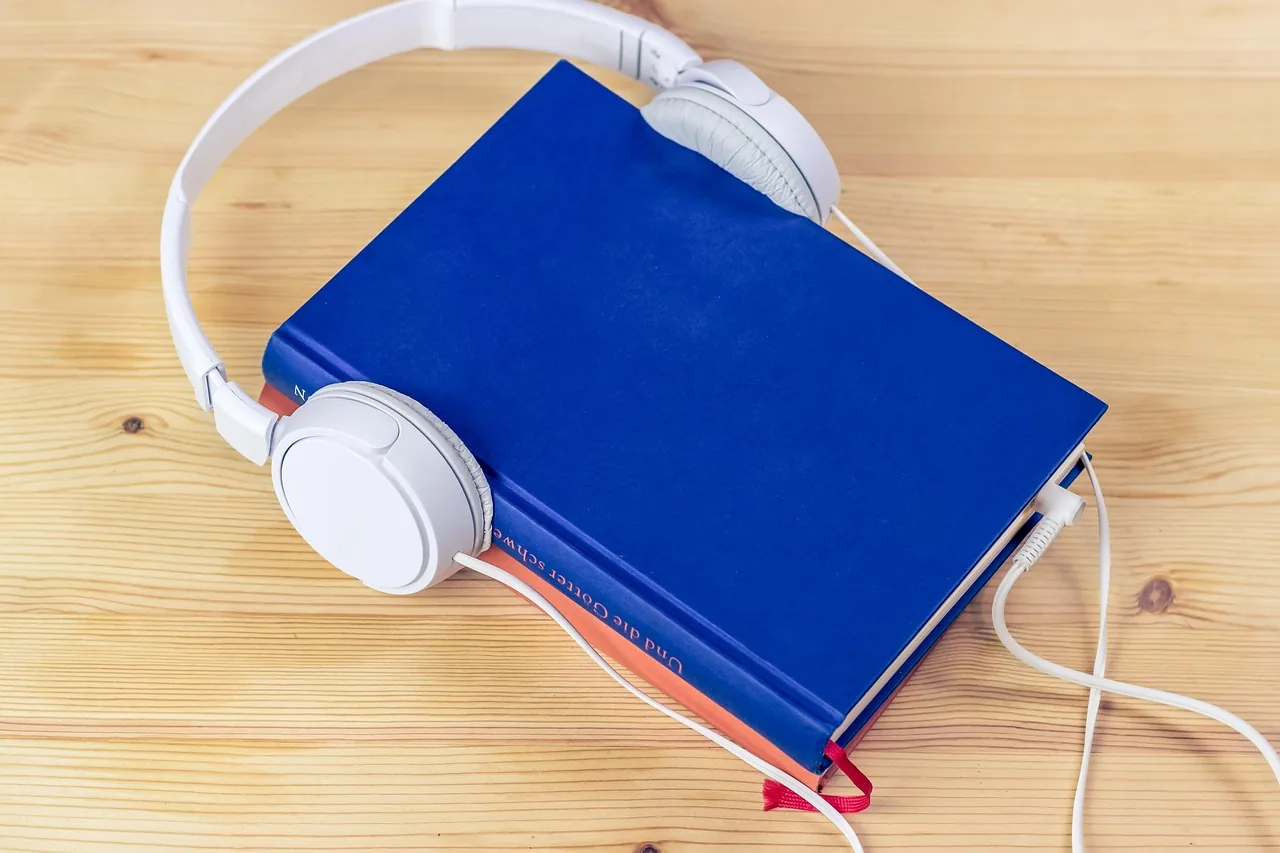 blue book with white headphones blue book with white headphones