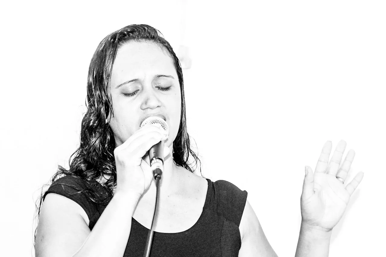 Singer with her eyes closed in black and white Singer with her eyes closed in black and white