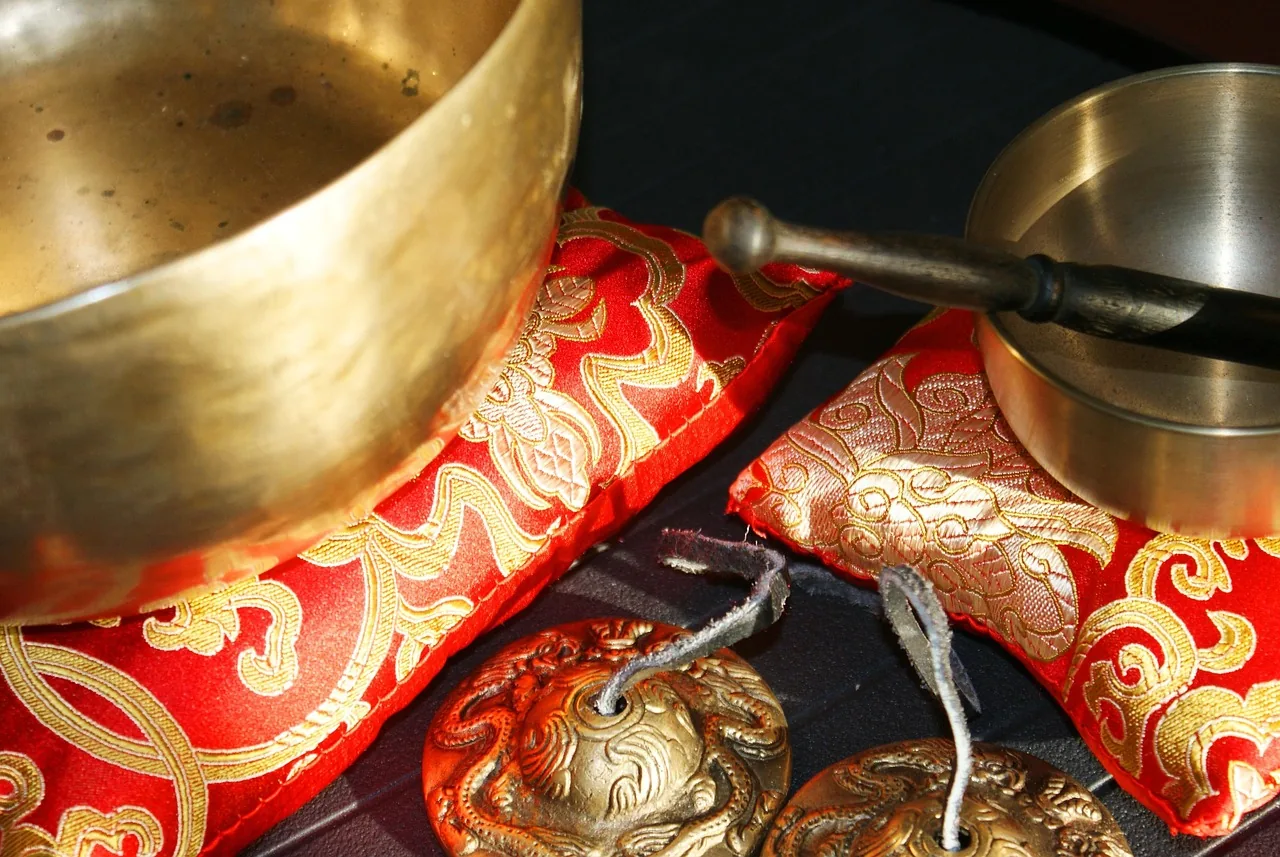 Tibetan singing bowls on red cushions with a mallet Tibetan singing bowls on red cushions with a mallet