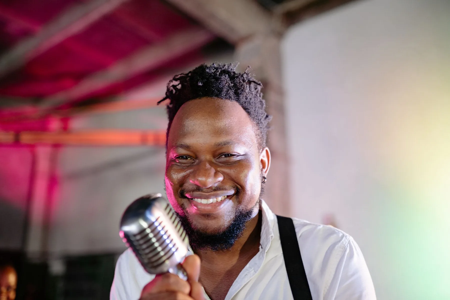 Smiling singer holding a retro microphone