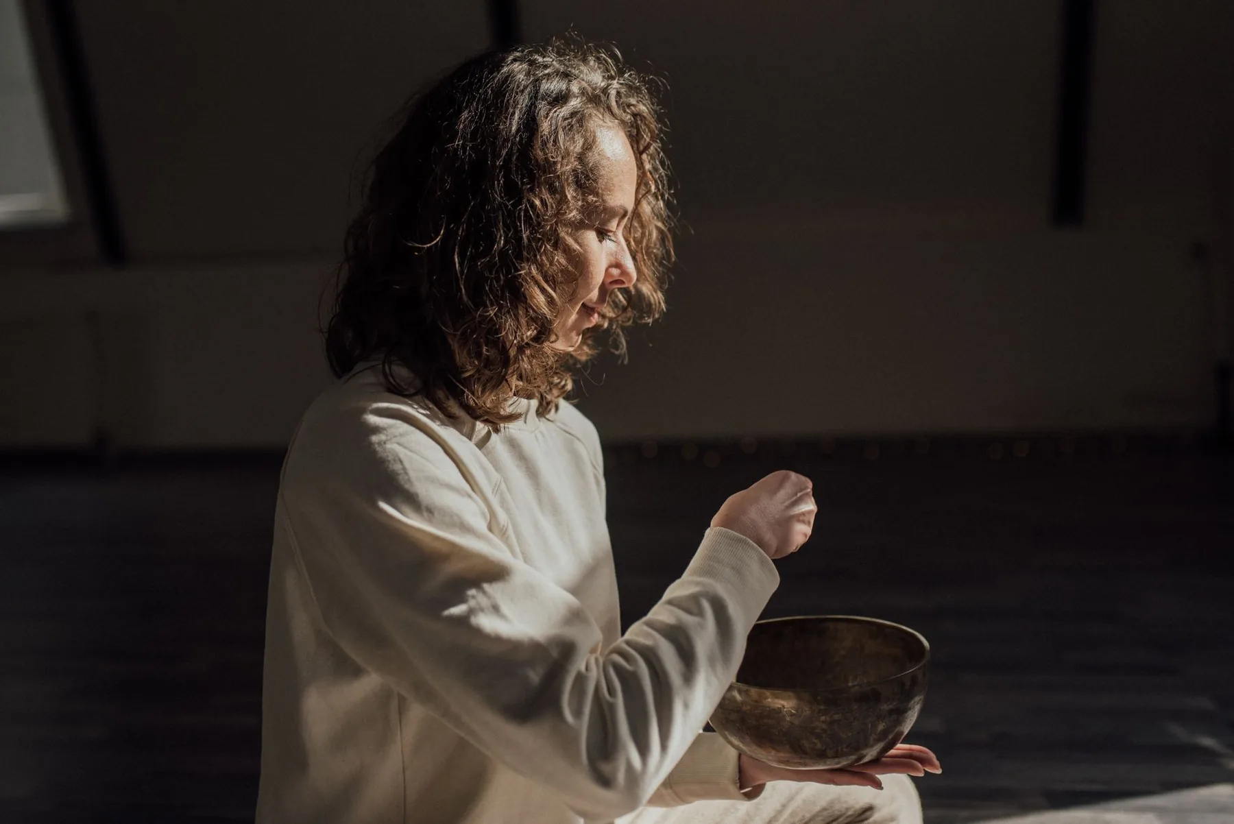 Woman holding a Tibetan singing bowl