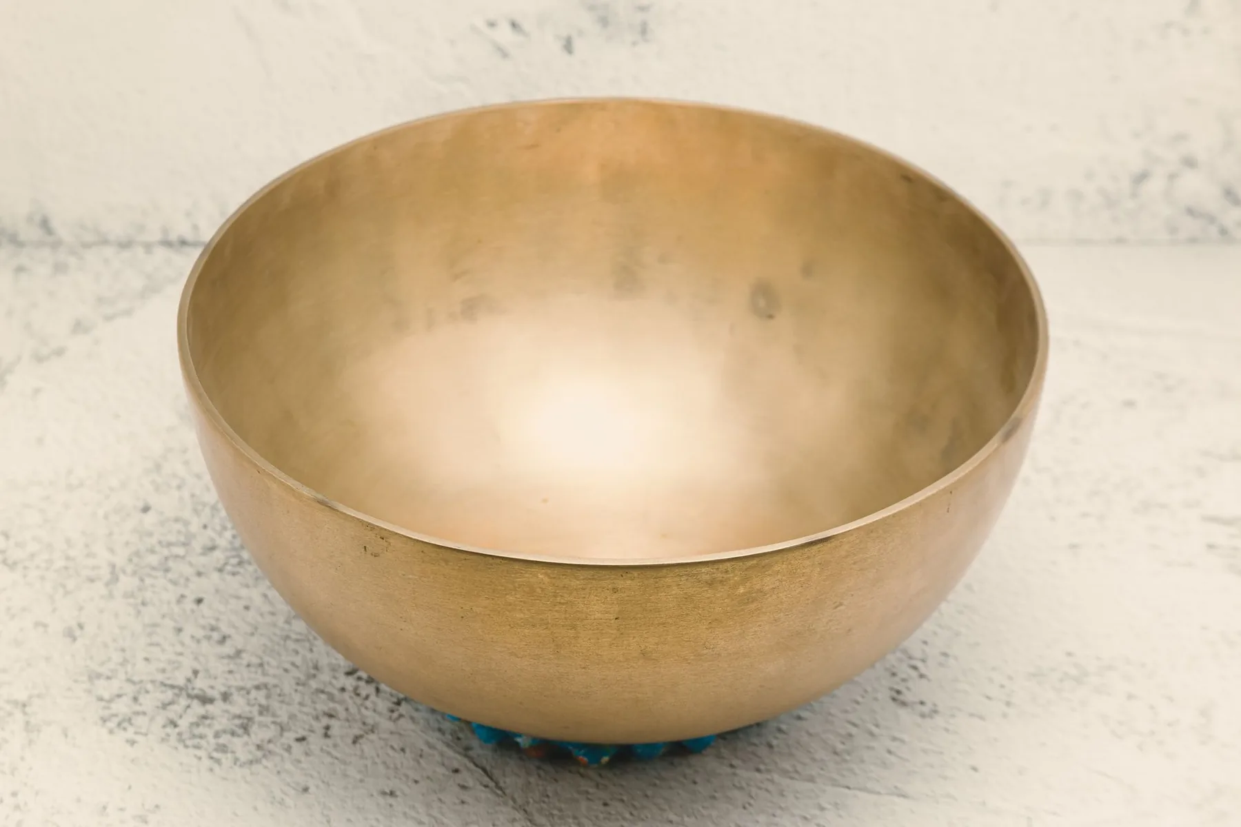Golden Tibetan singing bowl on a cushion Golden Tibetan singing bowl on a cushion