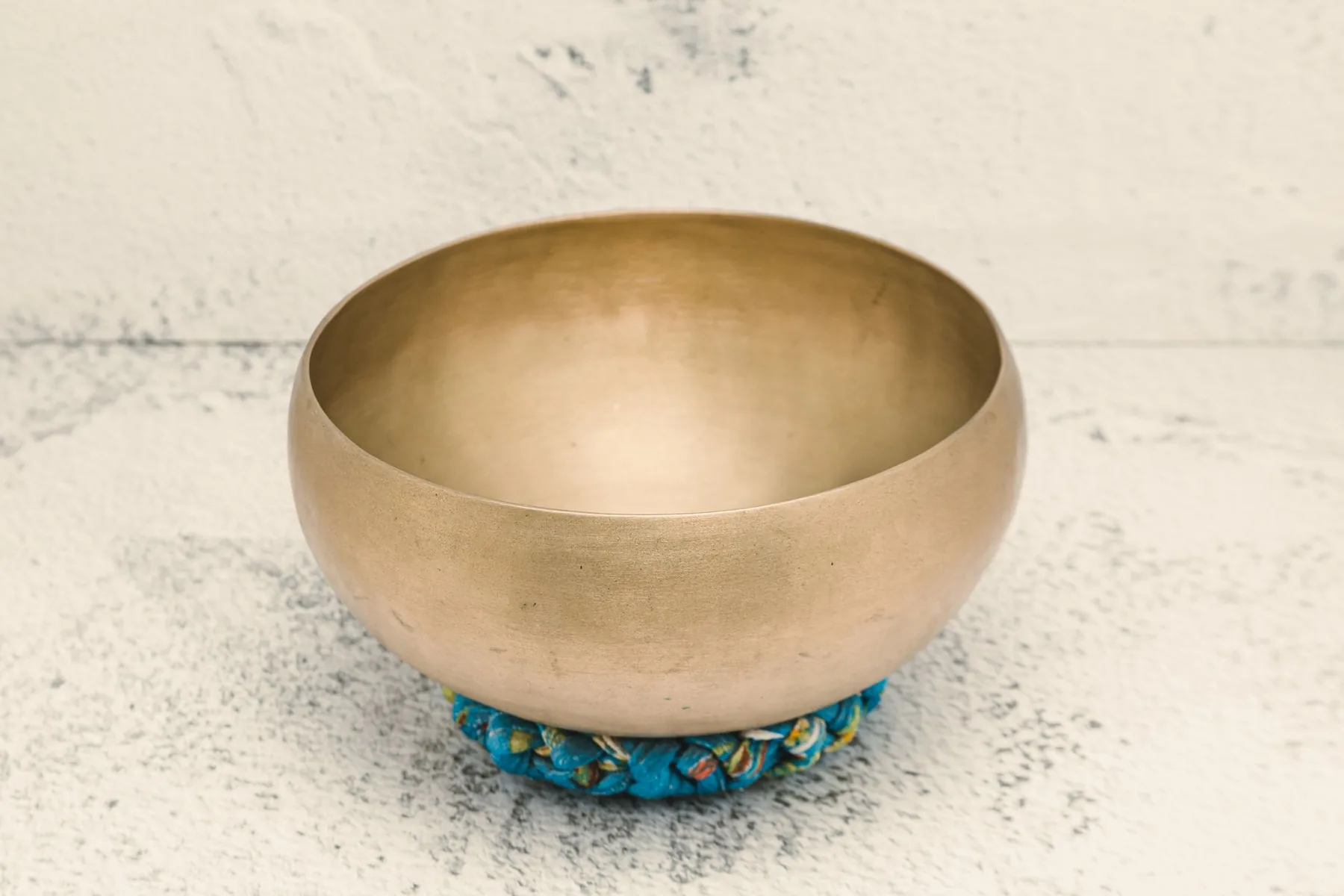 Tibetan singing bowl on a blue cushion Tibetan singing bowl on a blue cushion